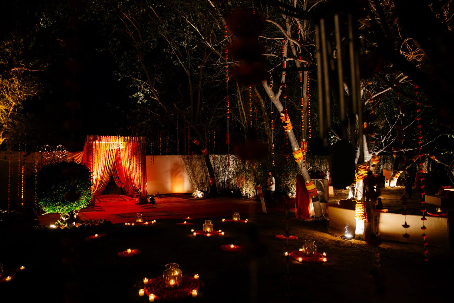 Night venue lit with marigolds and candles