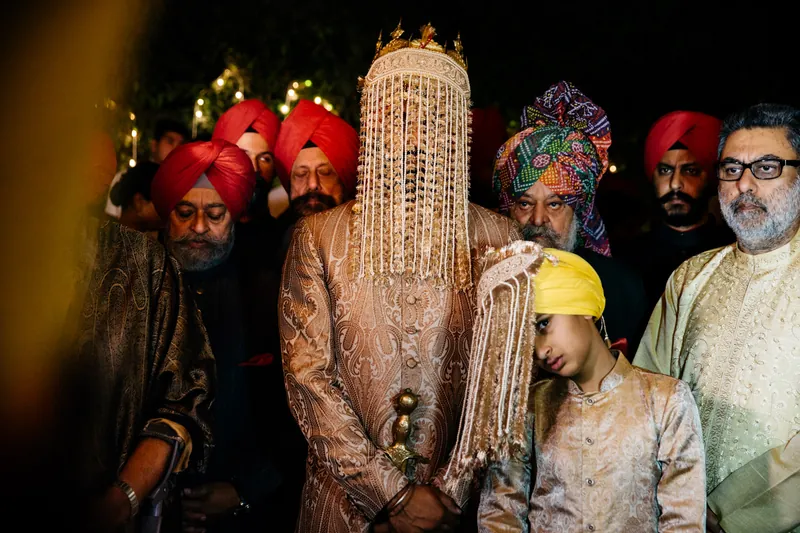 Groom surrounded by men in red turbans